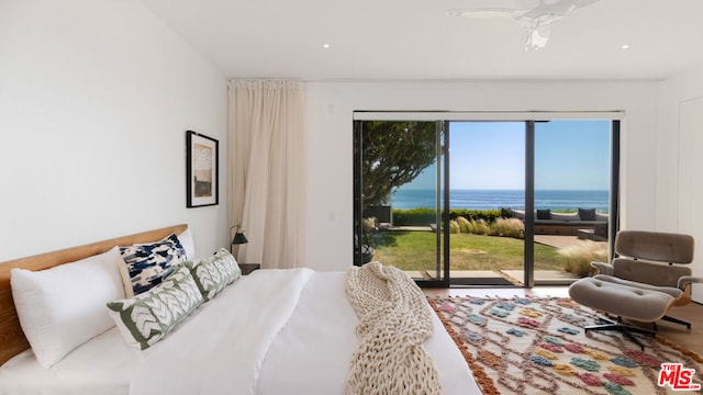 bedroom featuring access to exterior and a water view