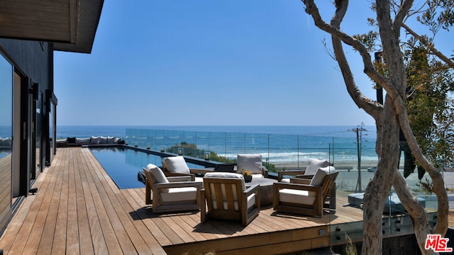 wooden terrace featuring a water view