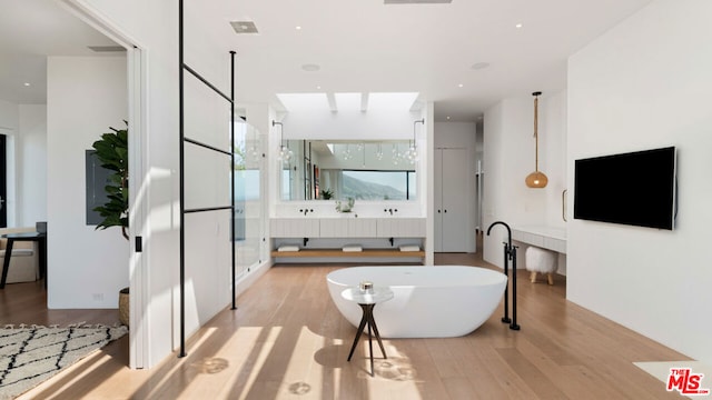 bathroom with vanity, plus walk in shower, and hardwood / wood-style flooring