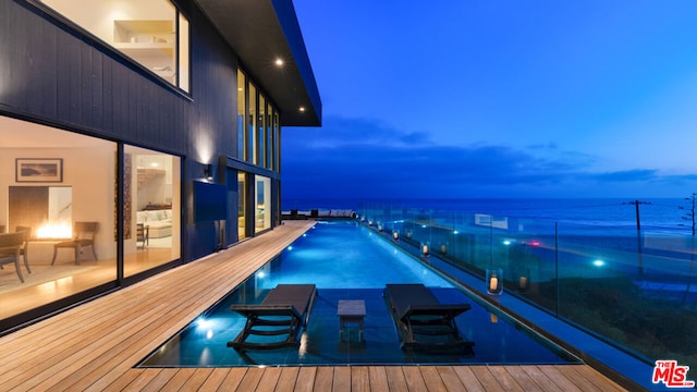 pool at dusk with a water view