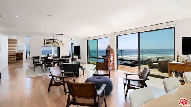 living room featuring a wealth of natural light, light hardwood / wood-style flooring, and expansive windows