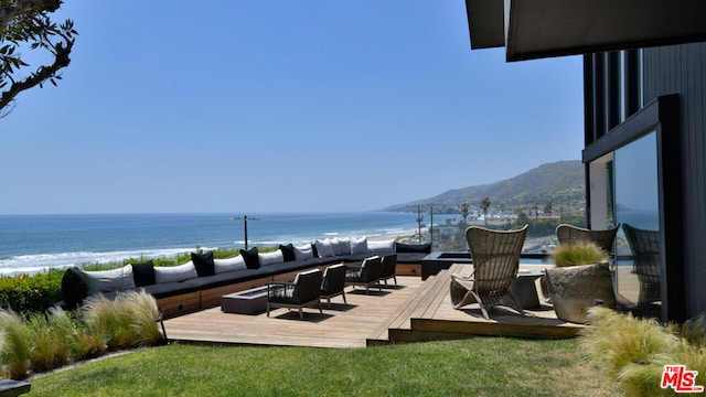 deck with a water view and an outdoor hangout area