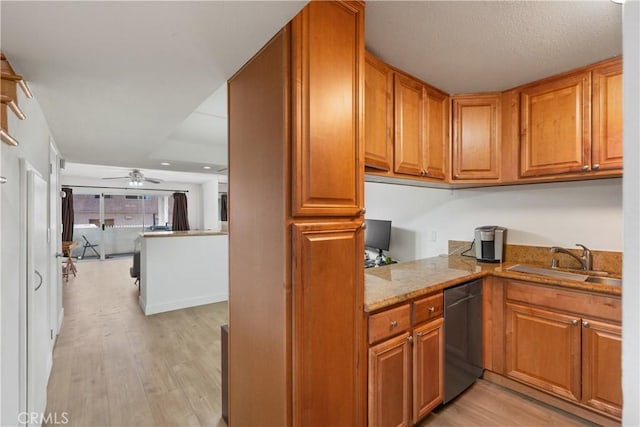 kitchen with dishwasher, ceiling fan, sink, light wood-type flooring, and light stone countertops