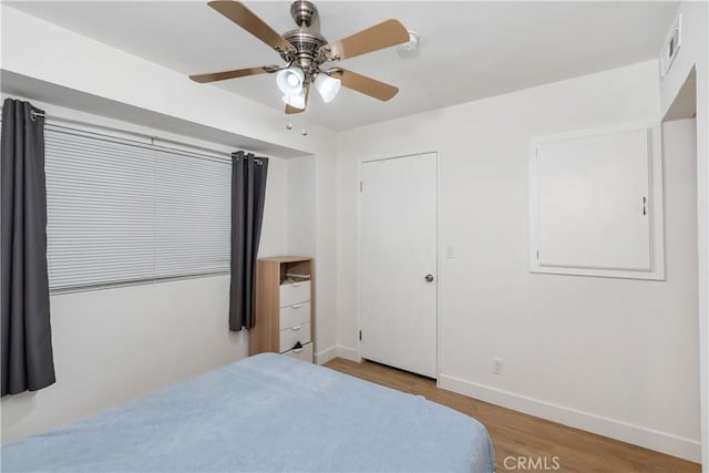 bedroom with light wood-type flooring and ceiling fan