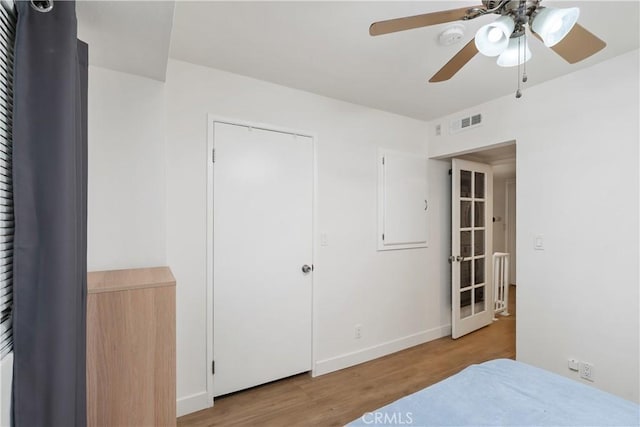 bedroom with ceiling fan, a closet, and light hardwood / wood-style flooring