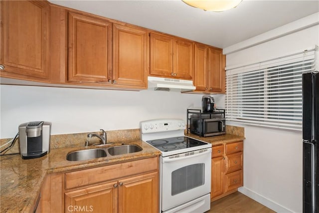 kitchen with light hardwood / wood-style flooring, sink, light stone counters, black fridge, and white electric stove