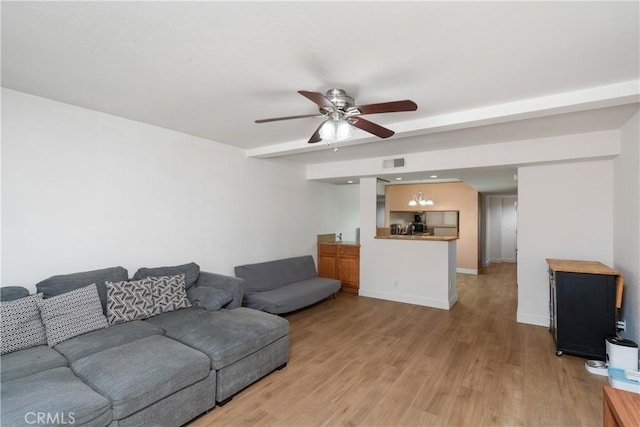 living room featuring ceiling fan and light hardwood / wood-style floors