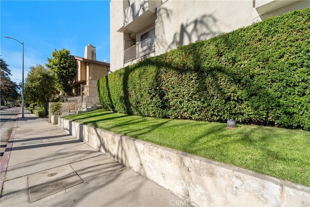 view of side of property with a yard