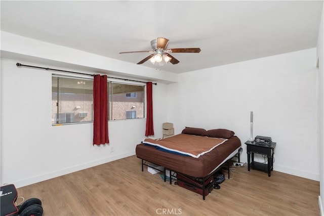 bedroom with ceiling fan and light hardwood / wood-style floors