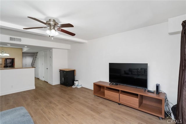 living room featuring ceiling fan and hardwood / wood-style floors