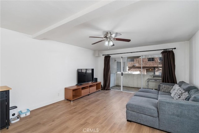 living room with hardwood / wood-style flooring, beam ceiling, and ceiling fan