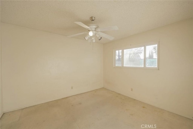 unfurnished room featuring ceiling fan and a textured ceiling