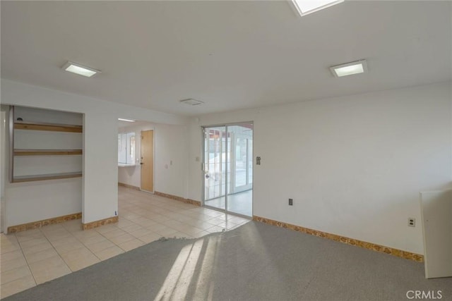 unfurnished room featuring light tile patterned floors