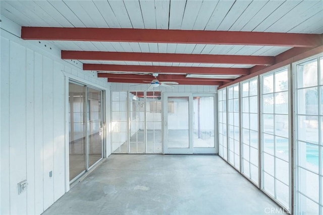 unfurnished sunroom with ceiling fan and beam ceiling