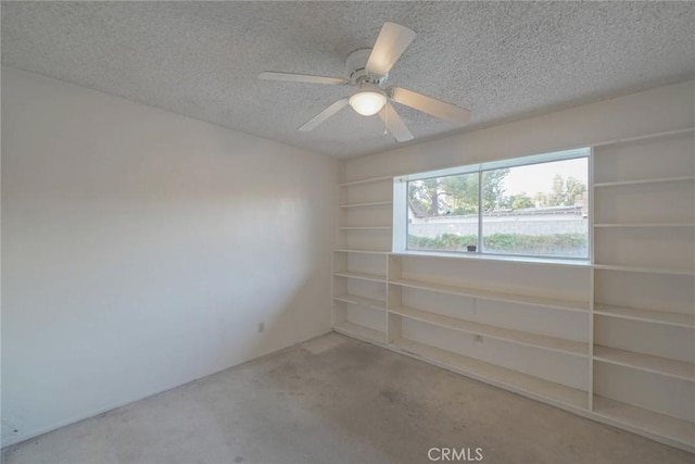 spare room with a textured ceiling and ceiling fan