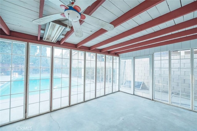 unfurnished sunroom featuring ceiling fan and beamed ceiling