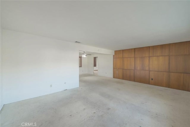 spare room featuring wood walls