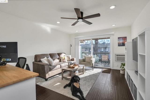 living room featuring ceiling fan, a wall mounted AC, and dark hardwood / wood-style floors