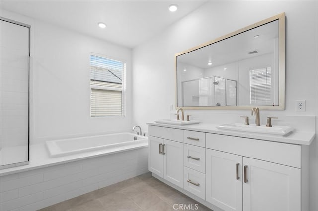 bathroom featuring tile patterned floors, shower with separate bathtub, and vanity