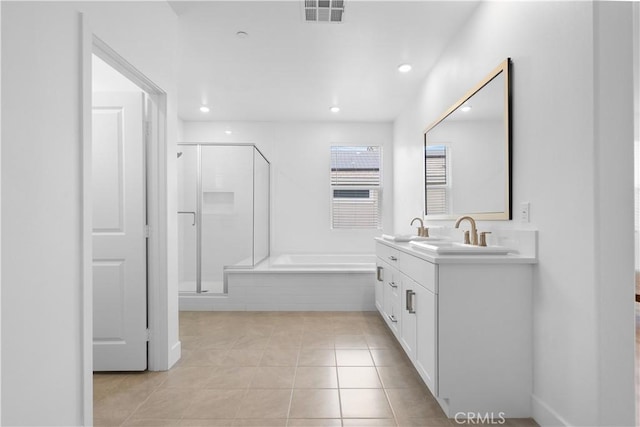 bathroom with tile patterned flooring, vanity, and separate shower and tub