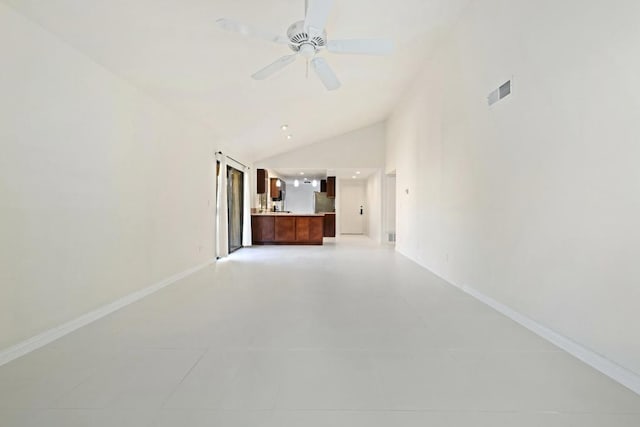 unfurnished living room featuring ceiling fan, light tile patterned floors, and high vaulted ceiling