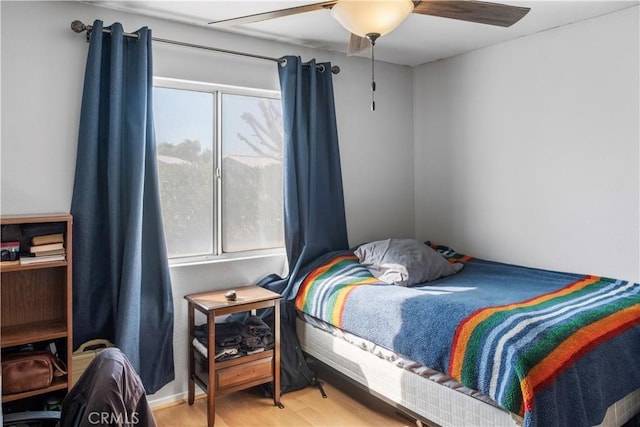 bedroom with ceiling fan and hardwood / wood-style floors