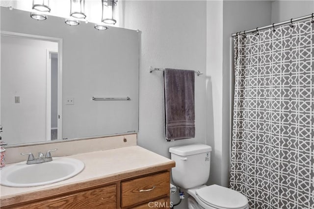 bathroom with vanity, toilet, and a shower with shower curtain