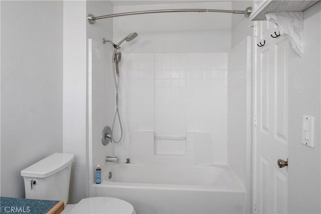 bathroom with washtub / shower combination and toilet