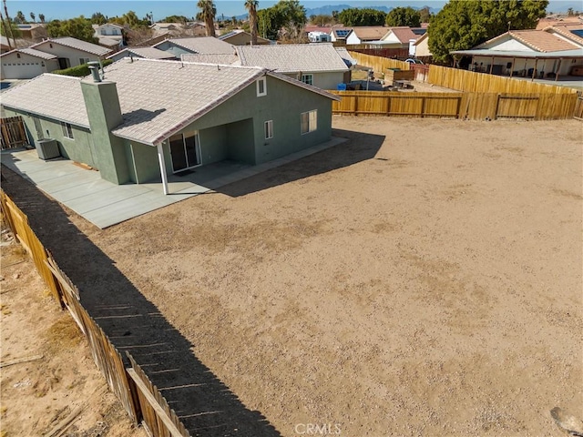 rear view of property featuring cooling unit and a patio area