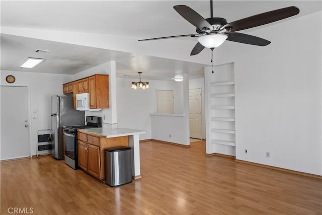 kitchen featuring light hardwood / wood-style flooring, kitchen peninsula, built in features, pendant lighting, and stainless steel appliances