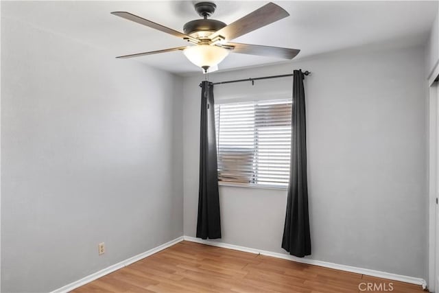 empty room with ceiling fan and light wood-type flooring