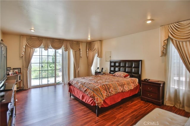 bedroom featuring access to exterior and dark hardwood / wood-style flooring