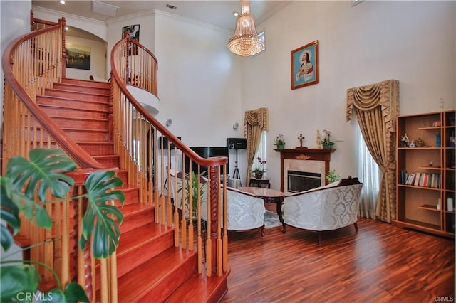 interior space with an inviting chandelier, ornamental molding, and hardwood / wood-style flooring