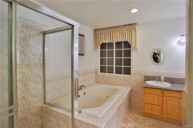 bathroom featuring separate shower and tub, vanity, tile patterned flooring, and tile walls