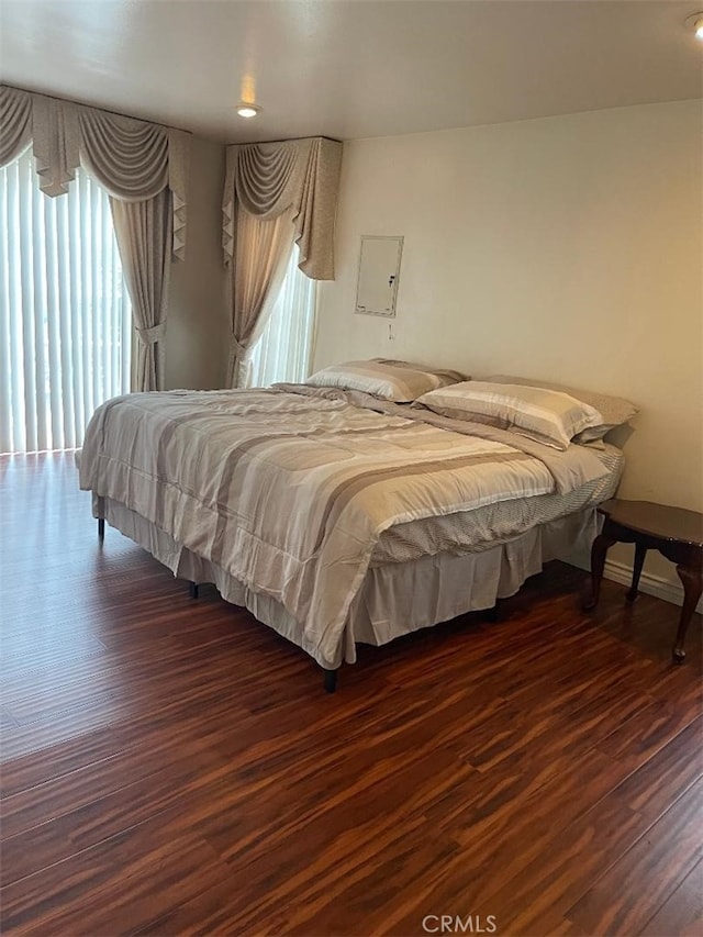 bedroom with dark wood-type flooring