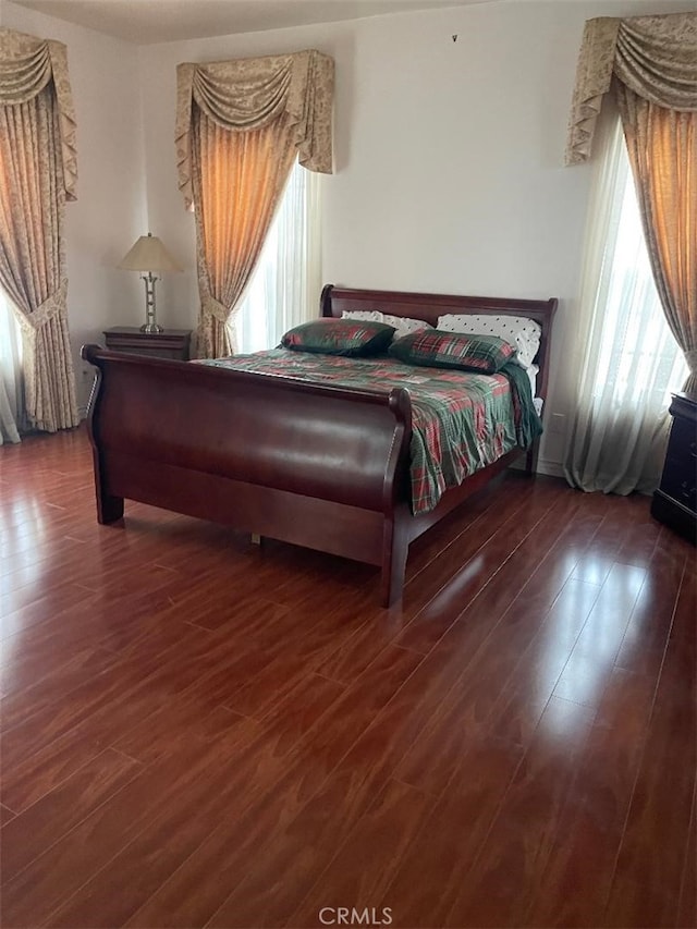 bedroom with dark wood-type flooring