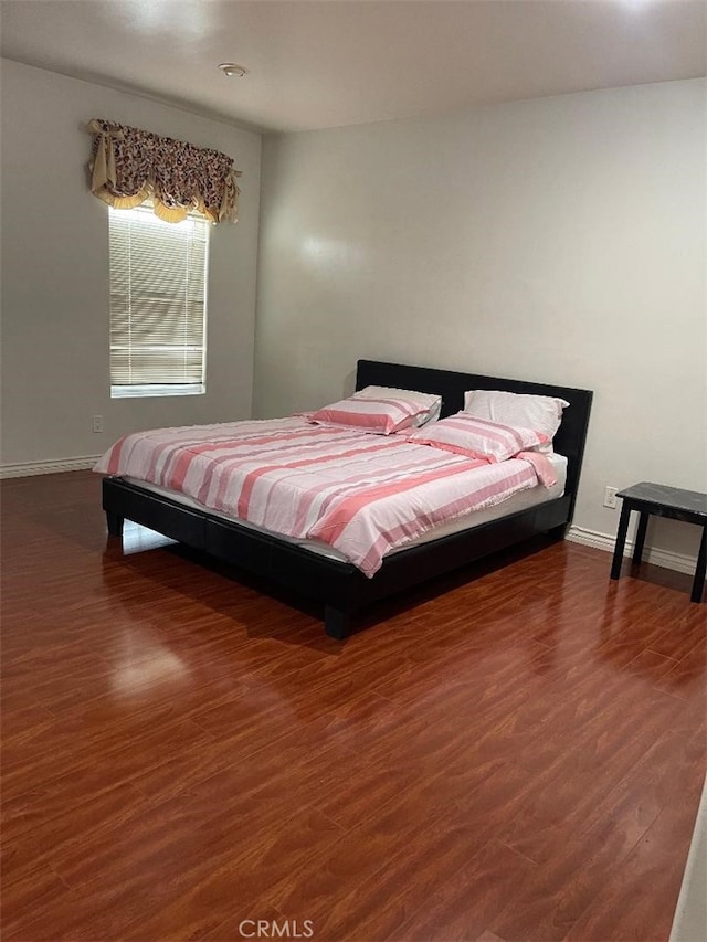 bedroom with dark wood-type flooring