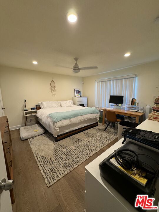 bedroom featuring ceiling fan and dark hardwood / wood-style flooring