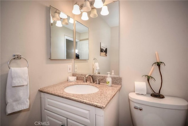 bathroom with toilet and vanity