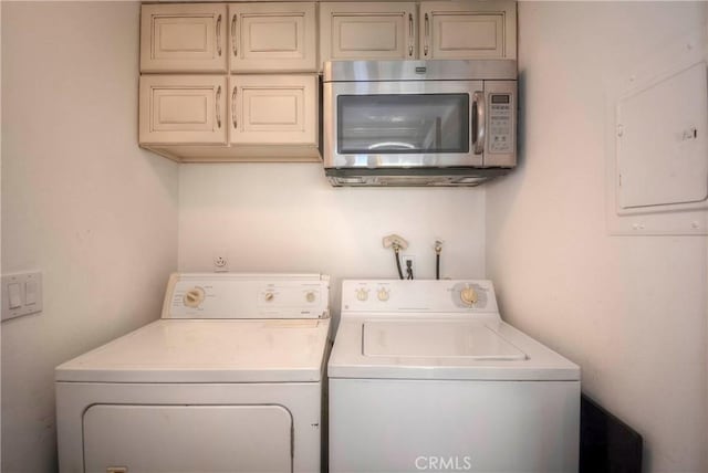 laundry area featuring electric panel and washer and clothes dryer