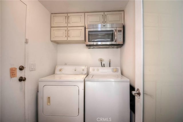 laundry area featuring washing machine and clothes dryer