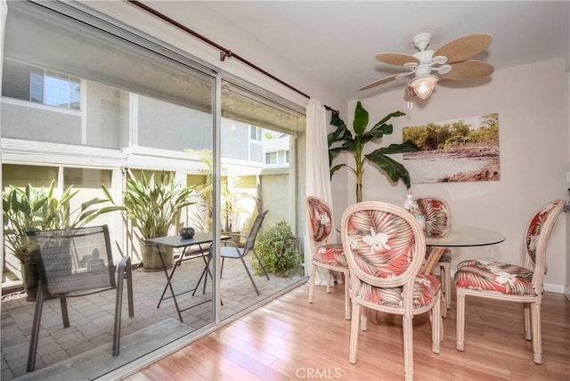 sunroom / solarium featuring ceiling fan