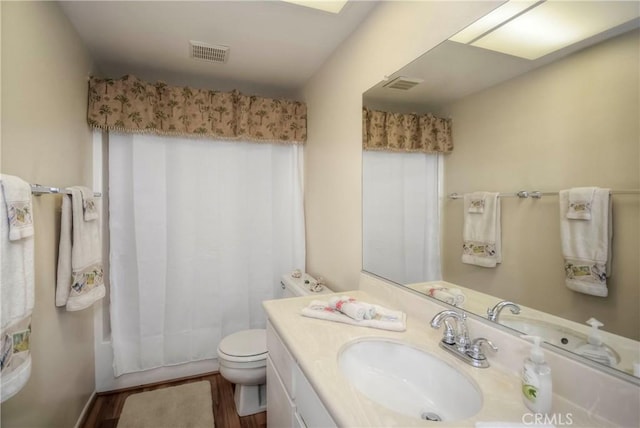 full bathroom with toilet, wood-type flooring, vanity, and shower / bath combo with shower curtain