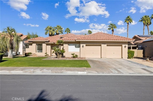 mediterranean / spanish home with a garage and a front yard