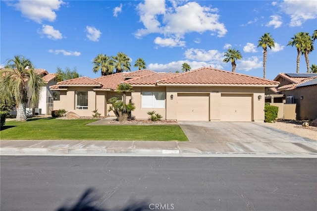 view of front of home featuring stucco siding, concrete driveway, a front lawn, and a tile roof