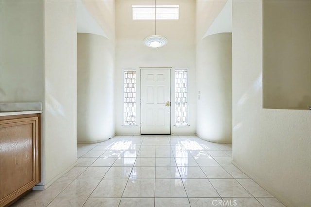 foyer entrance with a towering ceiling