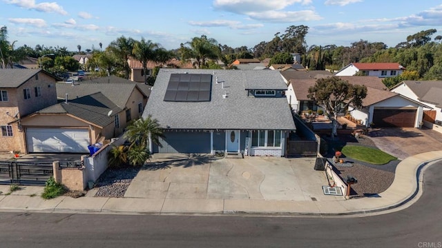 view of front of property with solar panels and a garage