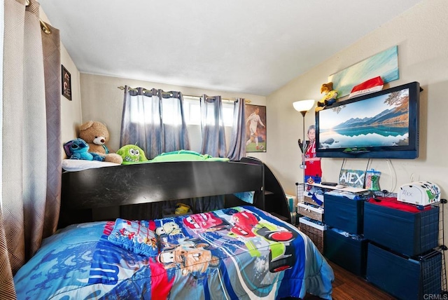 bedroom with dark hardwood / wood-style floors