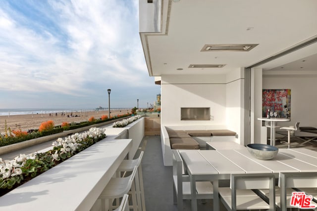 view of patio / terrace with a balcony and a water view