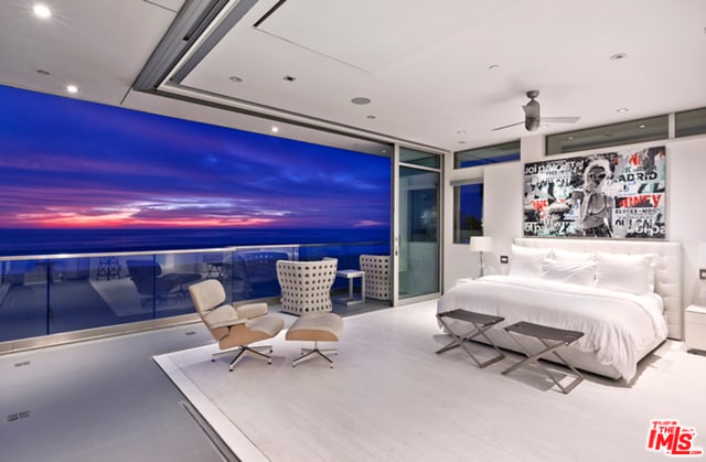 bedroom with ceiling fan and a wall of windows